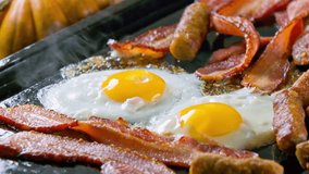 Delicious Breakfast Sizzle: Mouth-Watering Eggs, Sausage, and Bacon Being Cooked to Perfection in High-Quality Stock Video Footage
