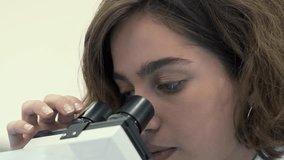 Portrait of Smart young student Looking Under the Microscope. In Elementary Classroom Cute Girl Uses Microscope.  - Powered by Shutterstock - Get 15% off with code: PIKWIZARD15