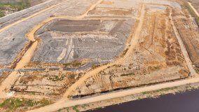 Landfill waste can have negative environmental impacts if not properly managed, as it can release harmful chemicals and gases into the environment during decomposition. Environmental pollution concept - Powered by Shutterstock - Get 15% off with code: PIKWIZARD15