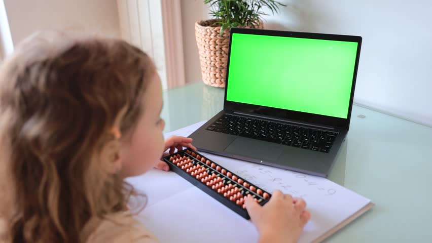 A girl from the back is engaged in mental arithmetic on the abacus online on a laptop, chroma key background. The concept of teaching children to count quickly, Russian mathematics.  | Shutterstock HD Video #1103237801