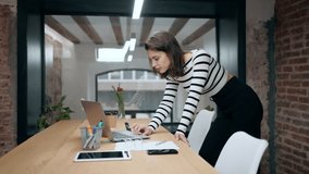 Video of architect engineer woman working with laptop standing in a modern office.