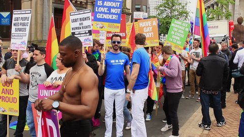 Birmingham Gay Pride 2015, England - people with the banners and Peter Tatchell marching in the parade. He is a British political campaigner best known for his work with LGBT social movements.