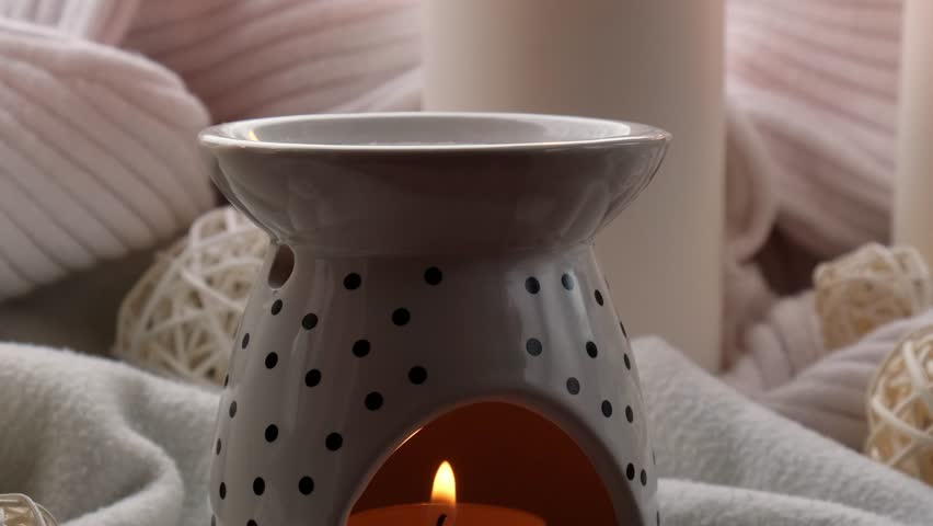 Aroma lamp with essential oil, aromatherapy at home, burning candle, dropping essential oil. Concept of home relaxation and anti stress. Natural Spa treatment Home fragnance at cozy home on the - Powered by Shutterstock - Get 15% off with code: PIKWIZARD15