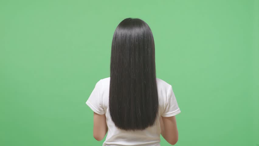 Back View Of A Woman Fluttering Her Long Black And Blond Straight Healthy Hair In The Green Screen Background Studio
 Royalty-Free Stock Footage #1103251795