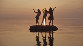 happy friends hippie family dancing on beach. party by lake, woman dancing. happy girls dancing on beach. Slow motion. beautiful girls having fun listening to music. teens girlfriends holiday disco. - Powered by Shutterstock - Get 15% off with code: PIKWIZARD15