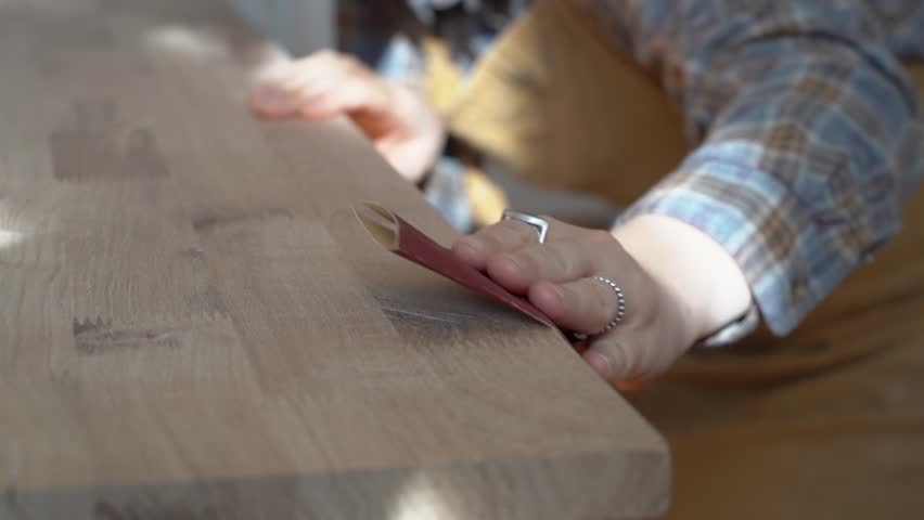 Carpenter woman works with wood in the workshop. Manufacture of furniture, wood. Private business, female work concept. | Shutterstock HD Video #1103258907