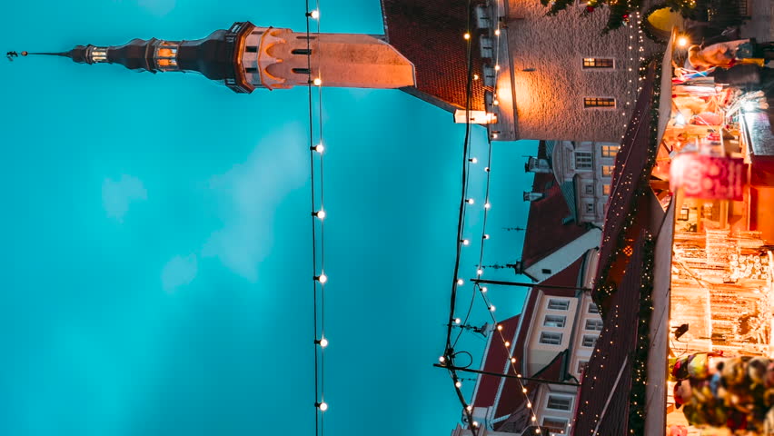 Tallinn, Estonia. vertical footage Hyperlapse Timelapse Time-lapse Of Traditional Christmas Market In Town Hall Square. Christmas Tree And Trading Houses. Famous Landmark UNESCO.