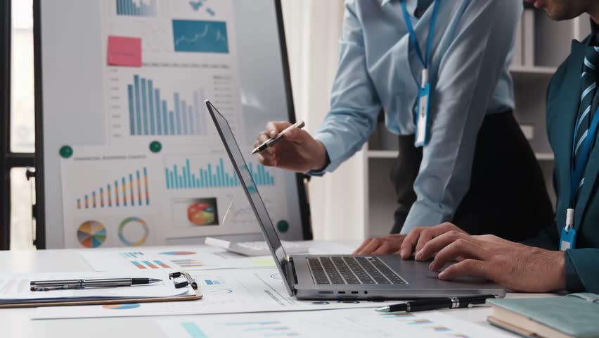 Young colleagues discuss business brainstorming and price charts analyze business people at the desk brilliantly in modern collaborative office teamwork ideas. Calculate personal tax for customers | Shutterstock HD Video #1103259975