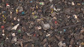 This visually powerful video captures a thought-provoking scene of waste and debris, both organic and inorganic, relentlessly falling and filling the entire screen. The cascade of refuse serves as a s