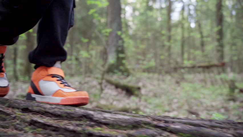 baby boy playing in the forest park. close-up child feet walking on a fallen tree log. happy family kid dream concept. a child in sneakers walks on a fallen tree in lifestyle park Royalty-Free Stock Footage #1103267819