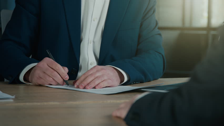 Close-up unrecognizable businessman signing contract to starting project investment putting signature on legal document men business partners make deal at office sign report making financial agreement