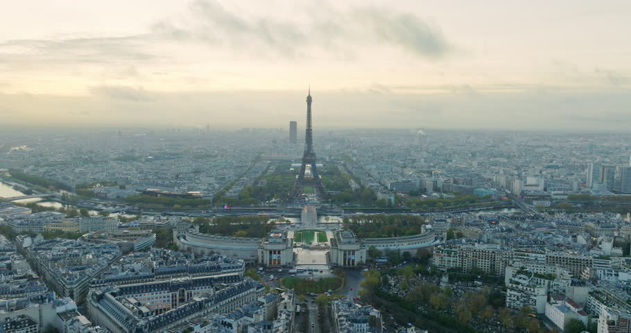 Beautiful view of famous Eiffel Tower in France with magical morning cloud and fog. Wide establishing aerial drone fly over seine river in paris city center, best travel destination landmark in Europe Royalty-Free Stock Footage #1103270779
