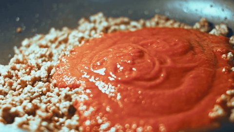Steam transformation effect of In a frying pan with vegetable oil fry minced meat, onions and carrots with tomato paste. Bolognese sauce. fried vegetables for soups, lasagna and different dishes. Home Adlı Stok Video