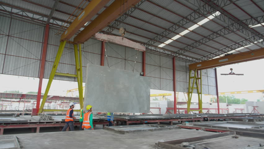 Team young asian engineer man walking while crane lifting precast concrete wall panel with professional at industrial factory, worker working with construction site, industry and transport concept. - Powered by Shutterstock - Get 15% off with code: PIKWIZARD15