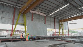 Team young asian engineer man walking while crane lifting precast concrete wall panel with professional at industrial factory, worker working with construction site, industry and transport concept. - Powered by Shutterstock - Get 15% off with code: PIKWIZARD15