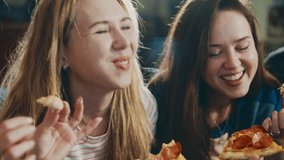 Multiracial happy young people eating pizza on sofa and laugh, cheerful students enjoying meal dining sitting together, diverse hungry friends sharing lunch at meeting sharing pizza. Everybody - Powered by Shutterstock - Get 15% off with code: PIKWIZARD15