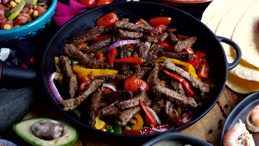 Fajitos fajita fajitas is a popular Mexican dish of meat and vegetables, cut into strips and grilled Royalty-Free Stock Footage #1103284781