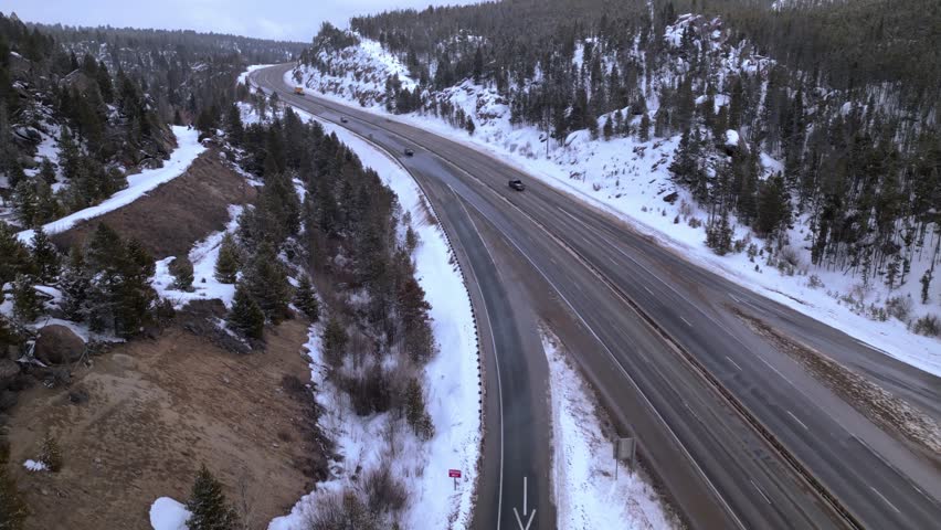 interstate highway road through the mountains. snow and ice on the road. winter road condition. American west mountains