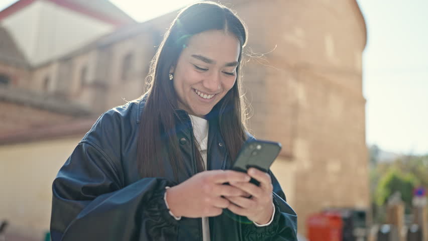 Young beautiful hispanic woman smiling confident using smartphone at street Royalty-Free Stock Footage #1103294917