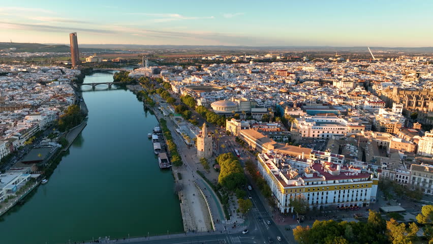 Aerial drone footage of the Seville city the Guadalquivir canal with the cathedral, the Torre del Oro, the tower of gold, Andalusia, Spaine