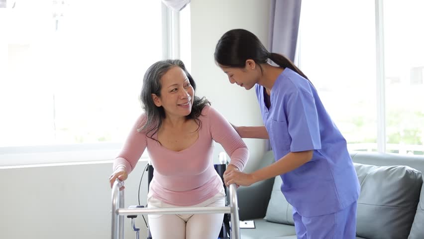 Nurse is helping a senior woman learn to walk with a cane. Physiotherapist doing physiotherapy for senior woman practicing walking. Royalty-Free Stock Footage #1103300327