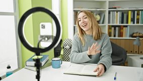 Young blonde woman student recording video tutorial at library university