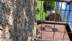 This 4K video footage captures a close-up shot of an empty climbing net on a children's playground.