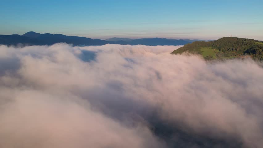 Aerial drone view of flying in sunrise clouds. The clouds are moving on camera. Concept of infinity, flight, ralax, freedom, peace