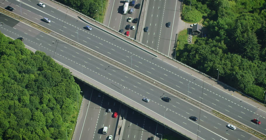 Aerial View of Traffic over a Major Highway Interchange, Full of Cars and Trucks.  London. England. Shot in 8K from Helicopter. Royalty-Free Stock Footage #1103311563