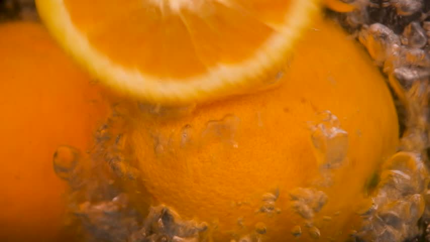 orange, orange splashing in water on balck background