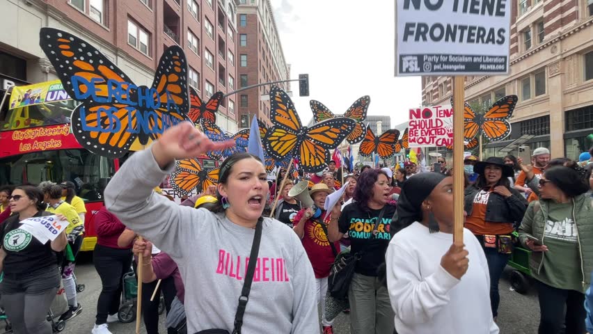 People participate in the annual May Day march to mark International Workers Day in downtown Los Angeles, Monday, May 1, 2023. 