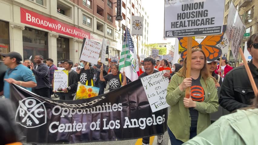 People participate in the annual May Day march to mark International Workers Day in downtown Los Angeles, Monday, May 1, 2023. 