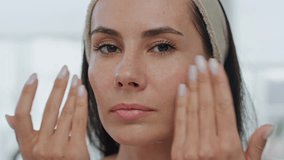 Portrait woman moisturize face cream indoors. Pov view relaxed lady applying beauty product moisturizing skin at morning. Brunette model pampering at home closeup. Feminine daily procedures concept - Powered by Shutterstock - Get 15% off with code: PIKWIZARD15