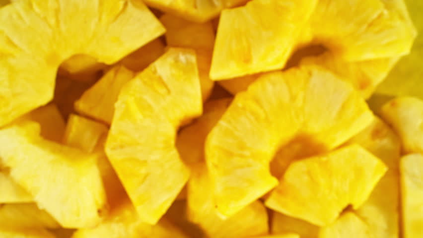 Super Slow Motion Shot of Flying Fresh Pineapple Slices. Filmed on high speed cinema camera, 1000 fps, placed on high speed cine bot.