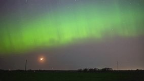 Aurora borealis lights the nighttime sky as the crescent moon sets below the horizon - time lapse - Powered by Shutterstock - Get 15% off with code: PIKWIZARD15