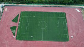 Cinematic aerial ascending tilt-up view of a soccer football field
