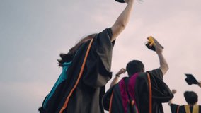 Close-up of graduation ceremony university high school graduates throwing cap on the blue sky.	