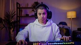 Professional cyber sportswoman takes part in cyber-sports championship. Proficient female plays online game intently speaking with gamers using headset