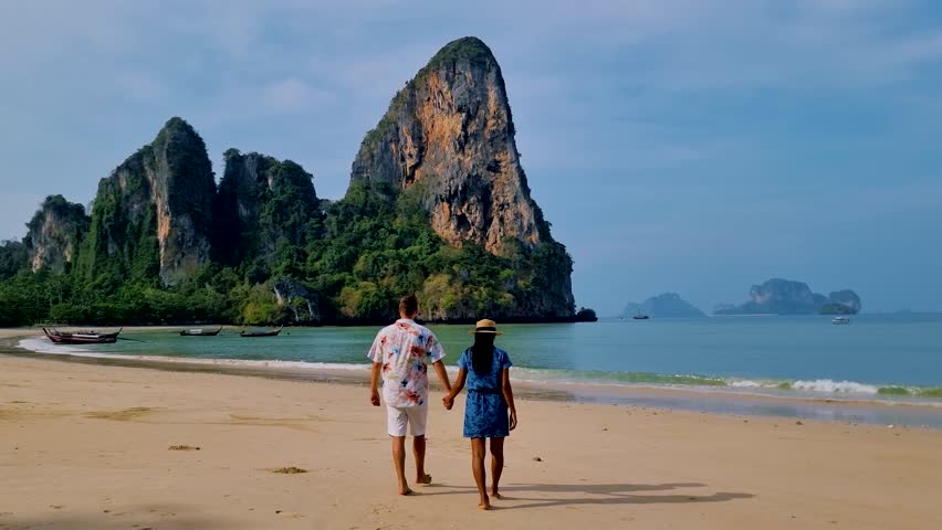 A couple of men and women walking on the beach of Railay Beach krabi Thailand Royalty-Free Stock Footage #1103338403