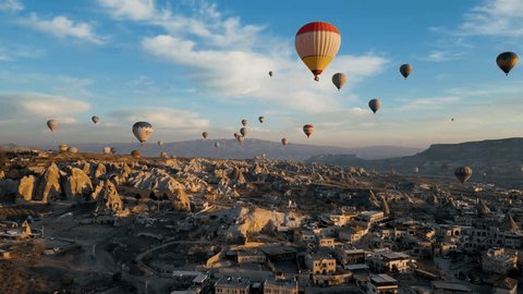 Drone - Hot Air Balloons, Cappadocia, Turkey 2023 - Slowly flying up towards red and white air balloon high with others over the city ஸ்டாக் வீடியோ