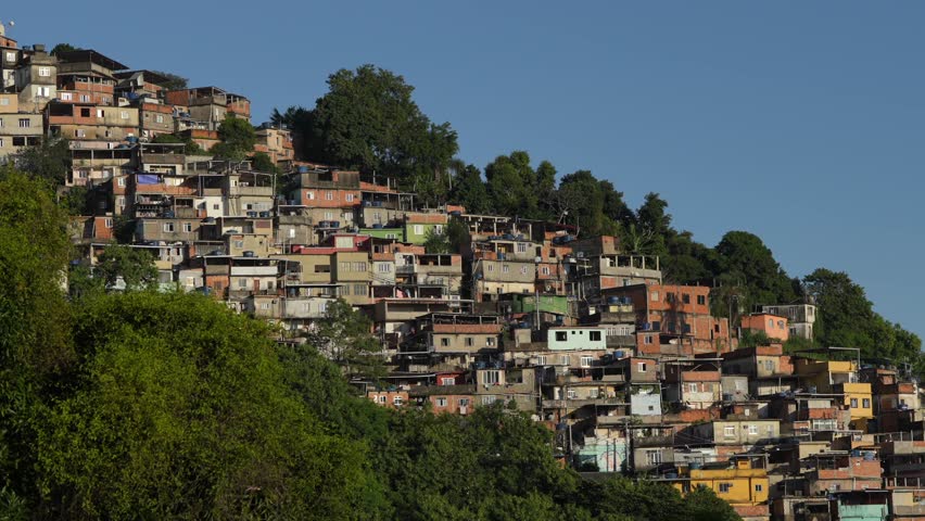 Rio de Janeiro 4k video pan camera movement with the landscape of houses in a favela region. Favelas of Rio de Janeiro, Brazil. Royalty-Free Stock Footage #1103340457
