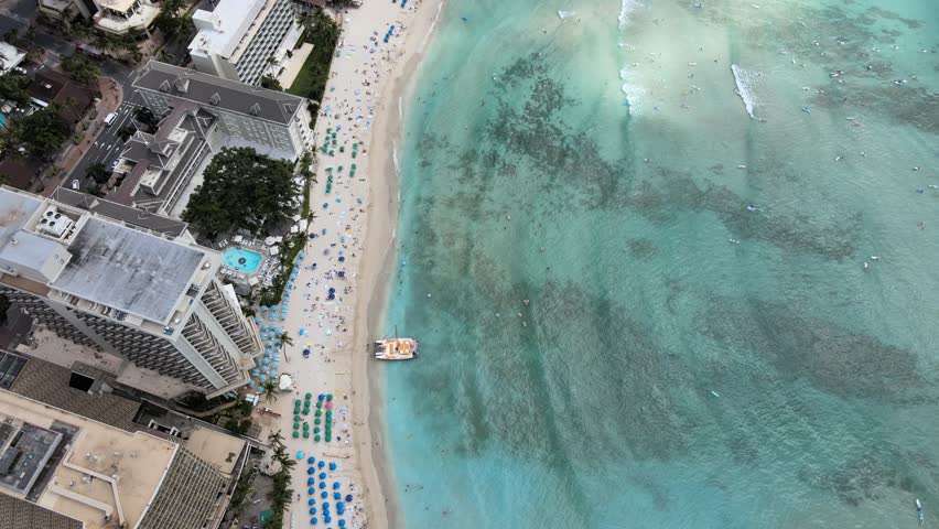 An aerial drone footage of Waikiki beach during daytime in Hawaii
