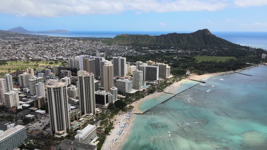 An aerial drone footage of Waikiki beach during daytime in Hawaii