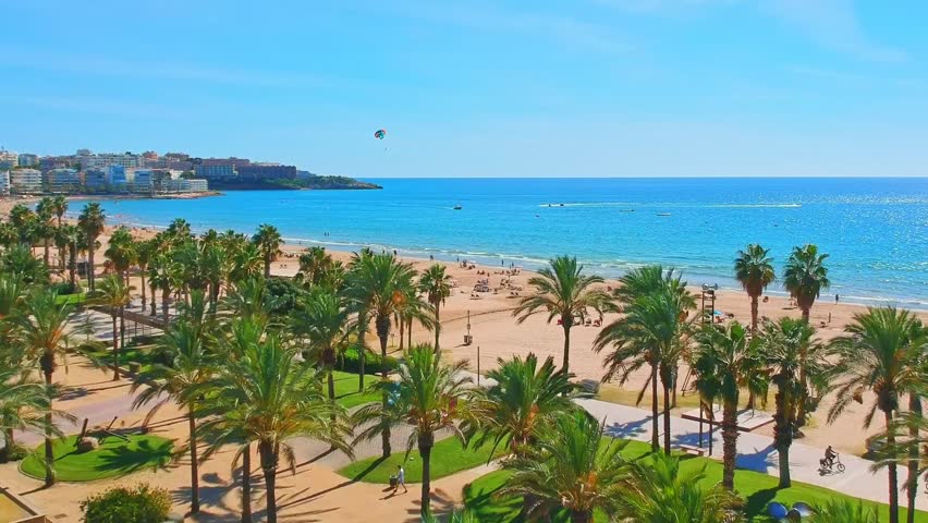 Beach, blue sea and palm trees in Salou city, Catalonia, Spain, Europe Royalty-Free Stock Footage #1103342101