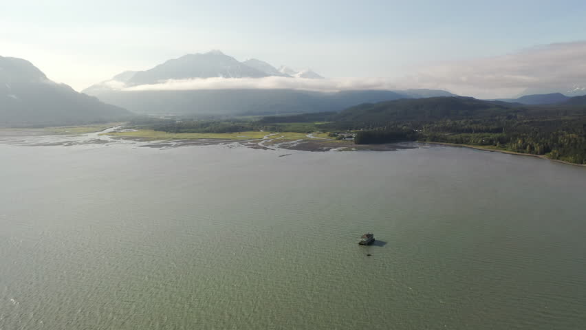 Barge mobile float camp on an inlet on the Kenai Peninsula, Seward, Alaska. Aerial drone view