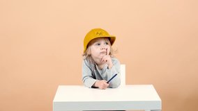 A girl in a construction helmet comes up with ideas for a design solution.