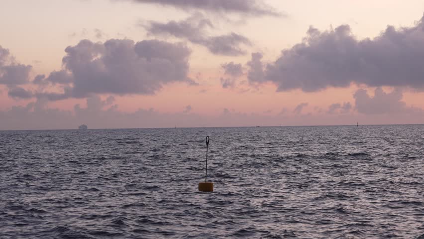 Yellow sea buoy in the middle of a calm sea during sunset - Italy Monterosso al Mare