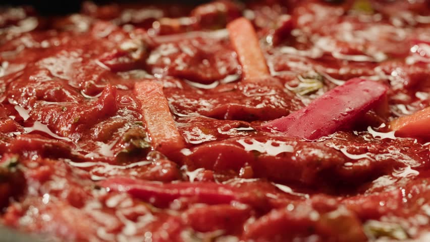 Cooking Mexican traditional food, sauce for tasty chili con carne boiling in pan, corn and pepper Mexican vegetables.