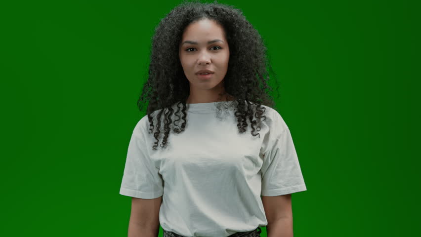 friendly woman with curly long hair dressed white shirt showing hand gesture call me Isolated on Green Screen