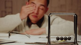 Tired Korean architect designer close-up. Professional engineer, overworked interior creator relaxing after working with new house project, blueprint plan, drafting building. - Powered by Shutterstock - Get 15% off with code: PIKWIZARD15